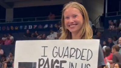 A fan holds up a Paige Bueckers poster