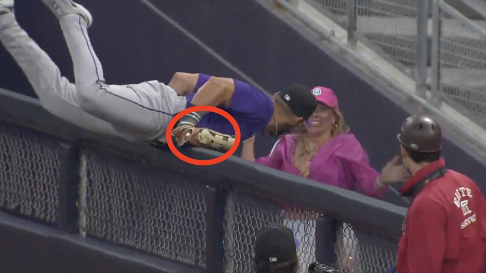 Rockies outfielder Nick Martini making a catch over the right-field fence
