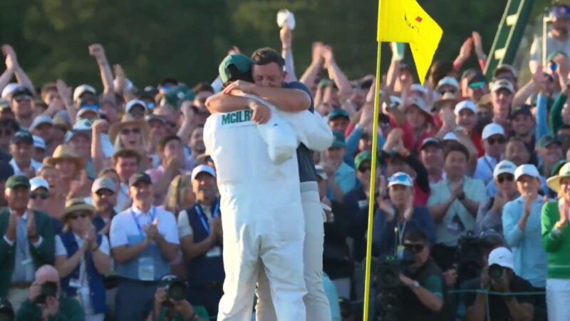 Rory McIlroy hugs his caddie