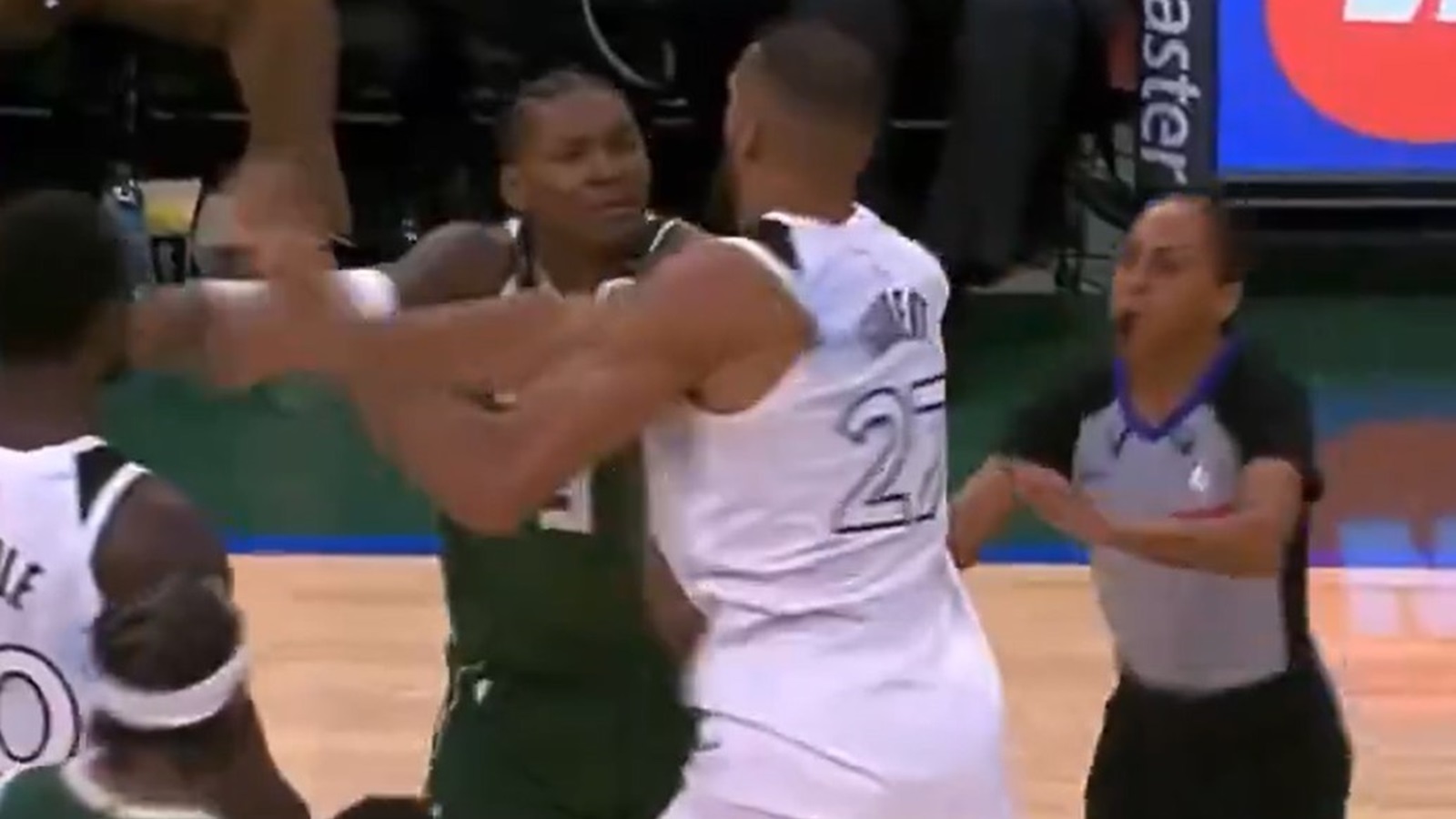 Rudy Gobert trading shoves with an opponent