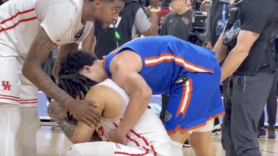 Florida's Walter Clayton Jr. consoling Houston's Emanuel Sharp