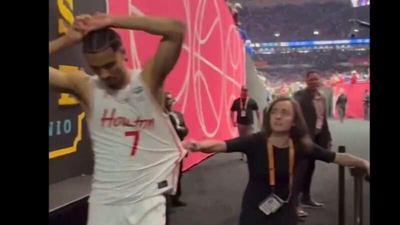 A woman grabs Milos Uzan