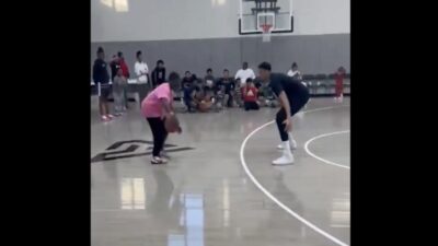 Giannis Antetokounmpo defends a kid at a camp
