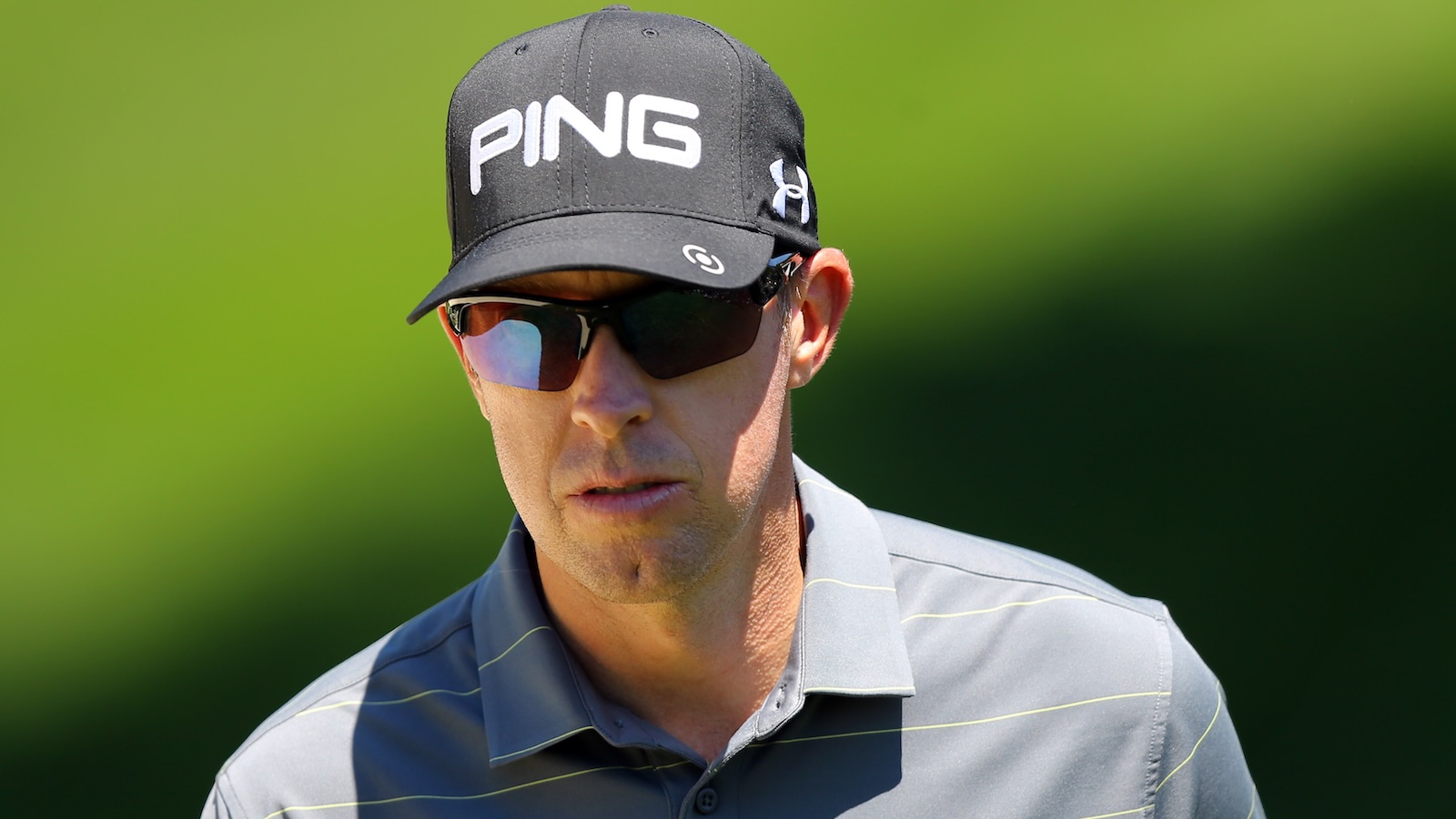 Hunter Mahan looks on