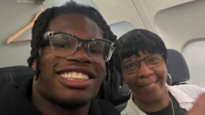 Travis Hunter takes a photo with a fan on a flight