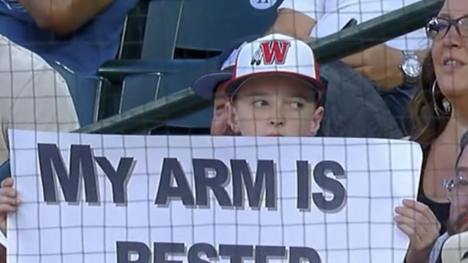 A young Rockies fan holds up a funny sign