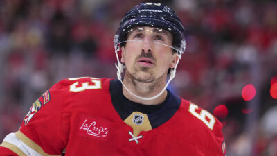 Brad Marchand in a Panthers uniform looking on