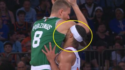 Josh Hart's face in Kristaps Porzingis' armpit