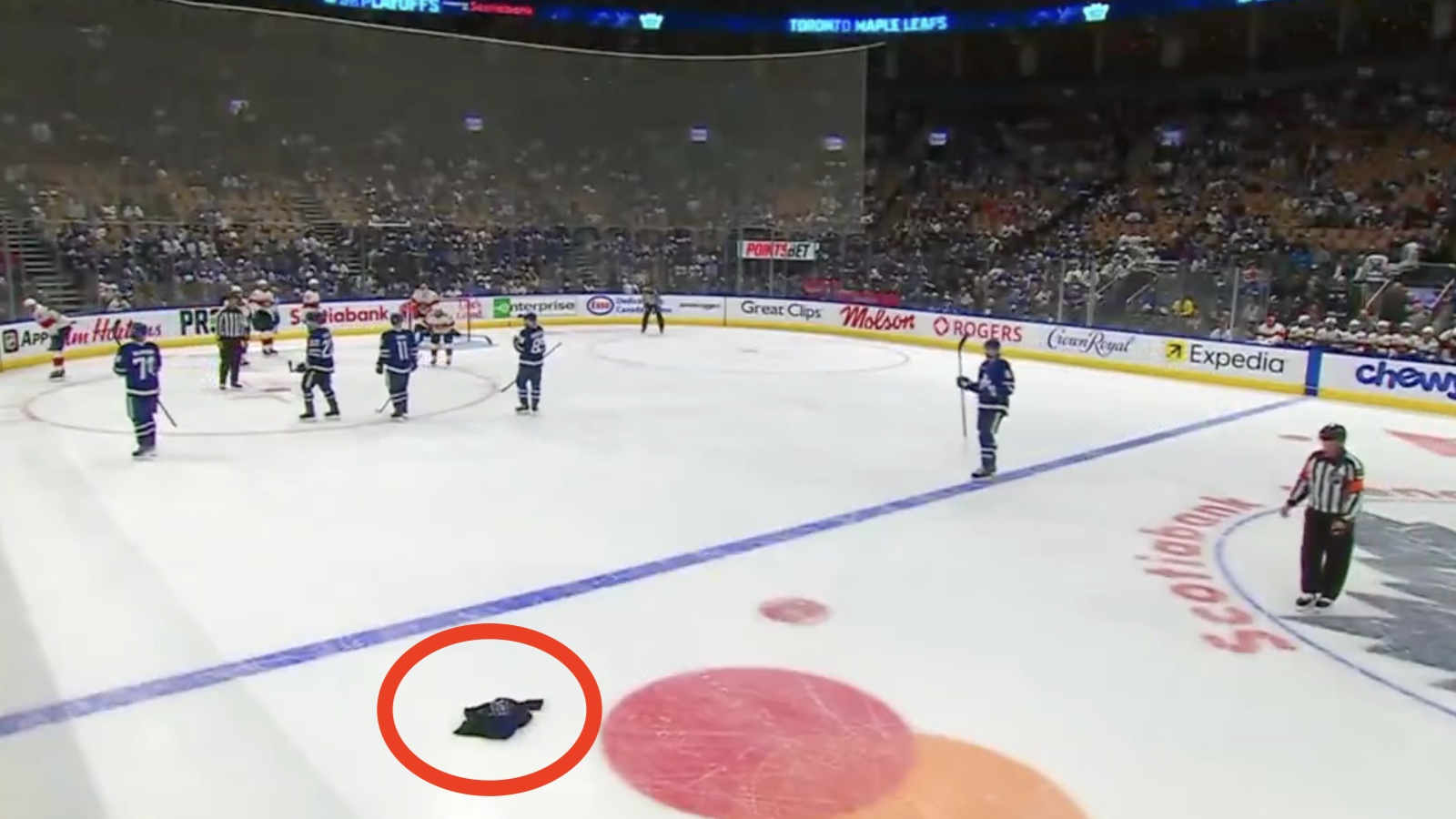 Maples Leafs fan throws a jersey onto the ice