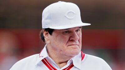 Pete Rose wearing a Reds hat
