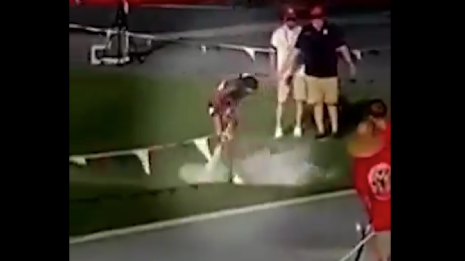 A high school sprinter sprays her feet with a fire extinguisher