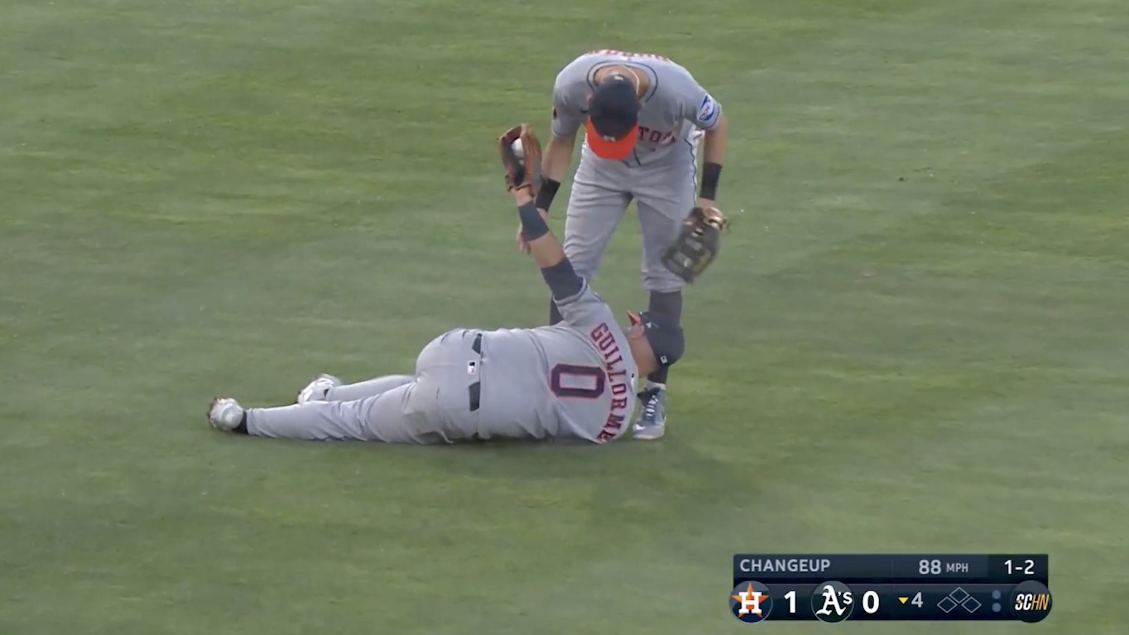 Astros' Luis Guillorme lying down in the infield with a ball in his glove