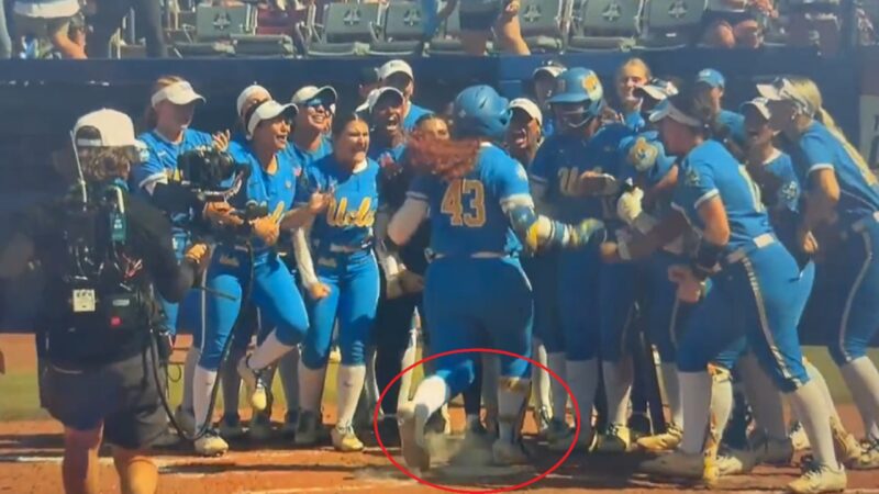 A UCLA player steps on home plate