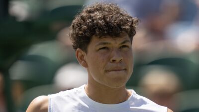 Ben Shelton looks on