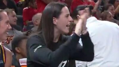 Caitlin Clark clapping on the bench