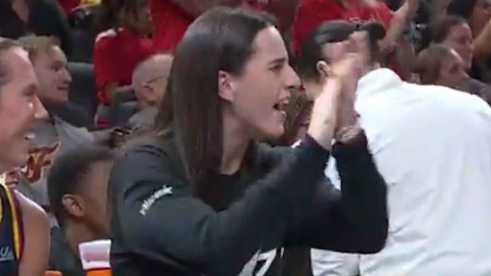 Caitlin Clark clapping on the bench