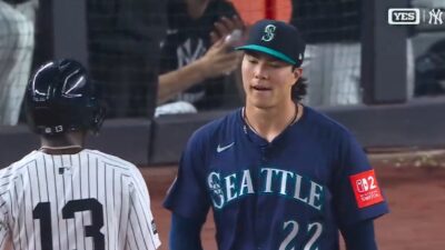 Bryan Woo walks on the field