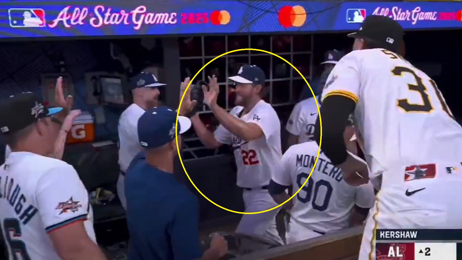 Clayton Kershaw high-fiving teammates in the dugout