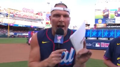 Pat McAfee holds a microphone