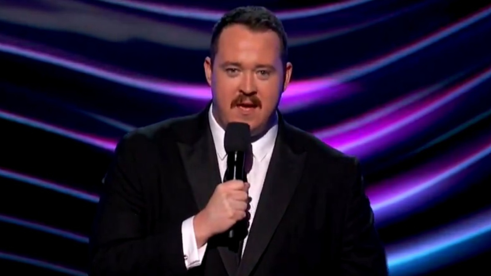 Shane Gillis with a microphone