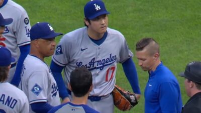 Shohei Ohtani surrounded by Dodgers personnel