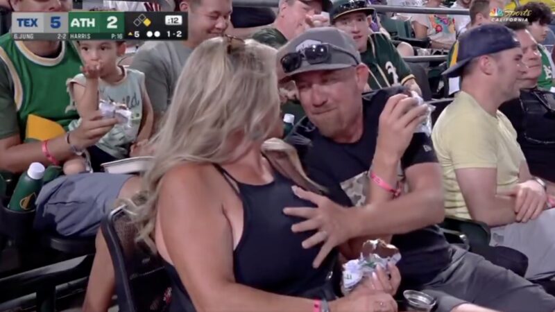 Athletics fan grabbing the boob of his companion