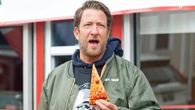 Dave Portnoy holding a pizza slice