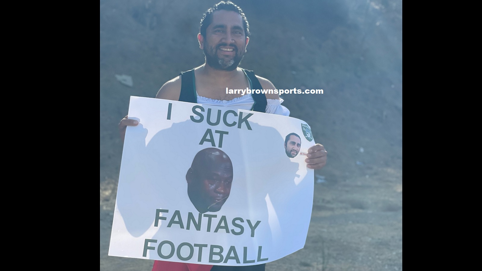 A man holds up a sign