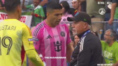 Luis Suarez confronts a Seattle Sounders coach before he spits on him.