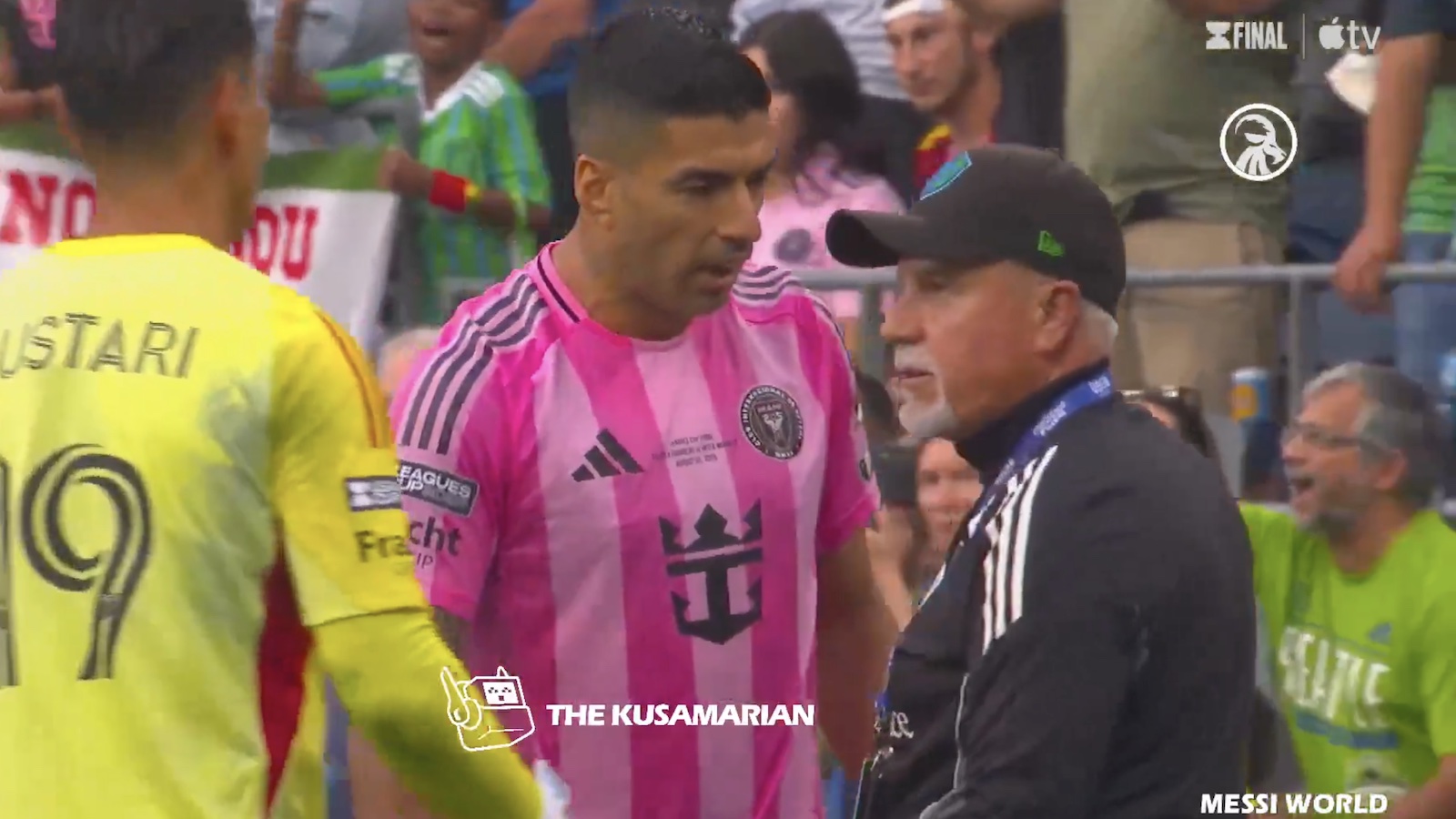 Luis Suarez confronts a Seattle Sounders coach before he spits on him.