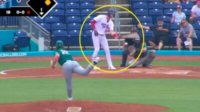 A minor leaguer swinging with one hand