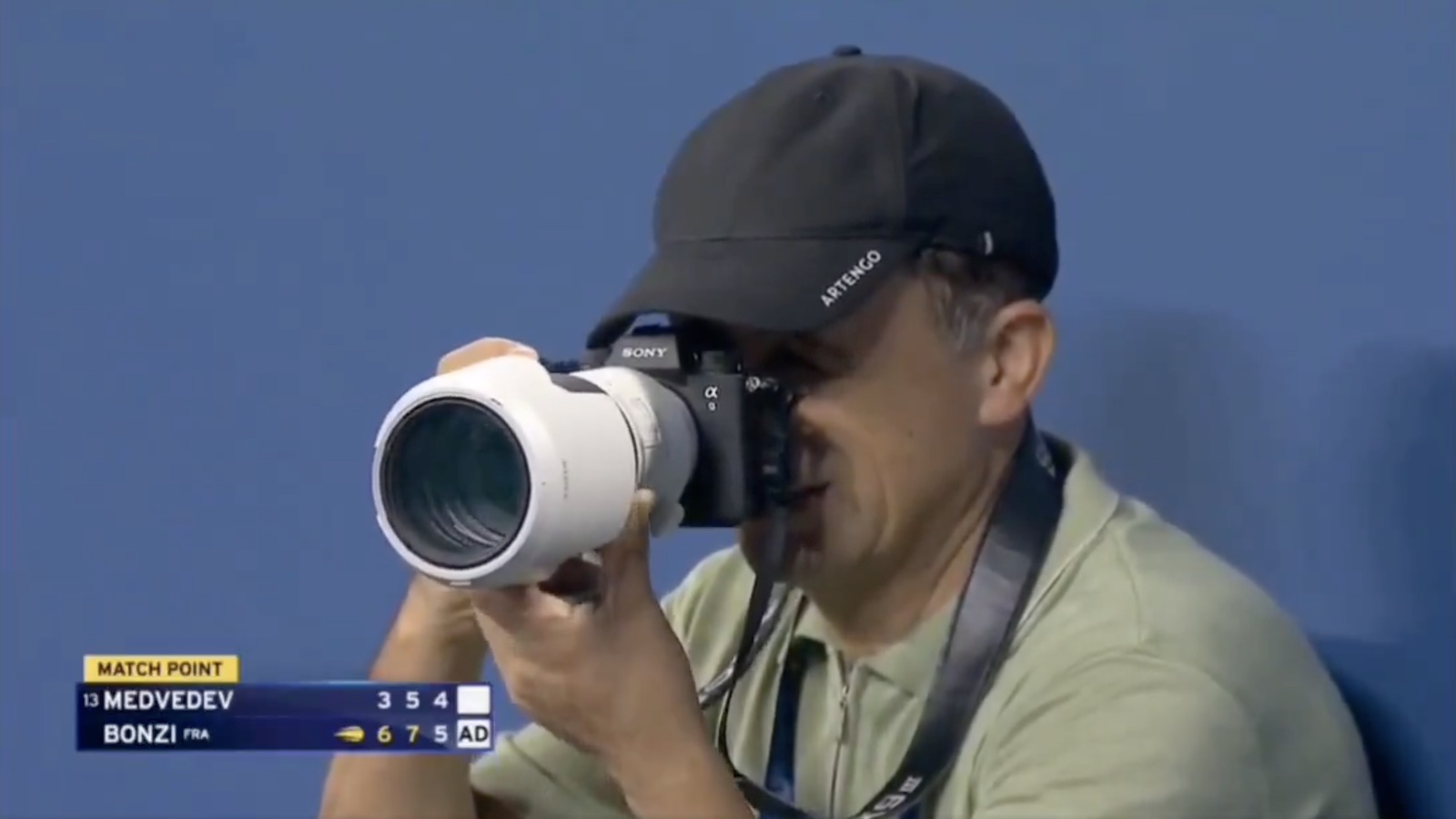 A photographer takes a photo during the US Open