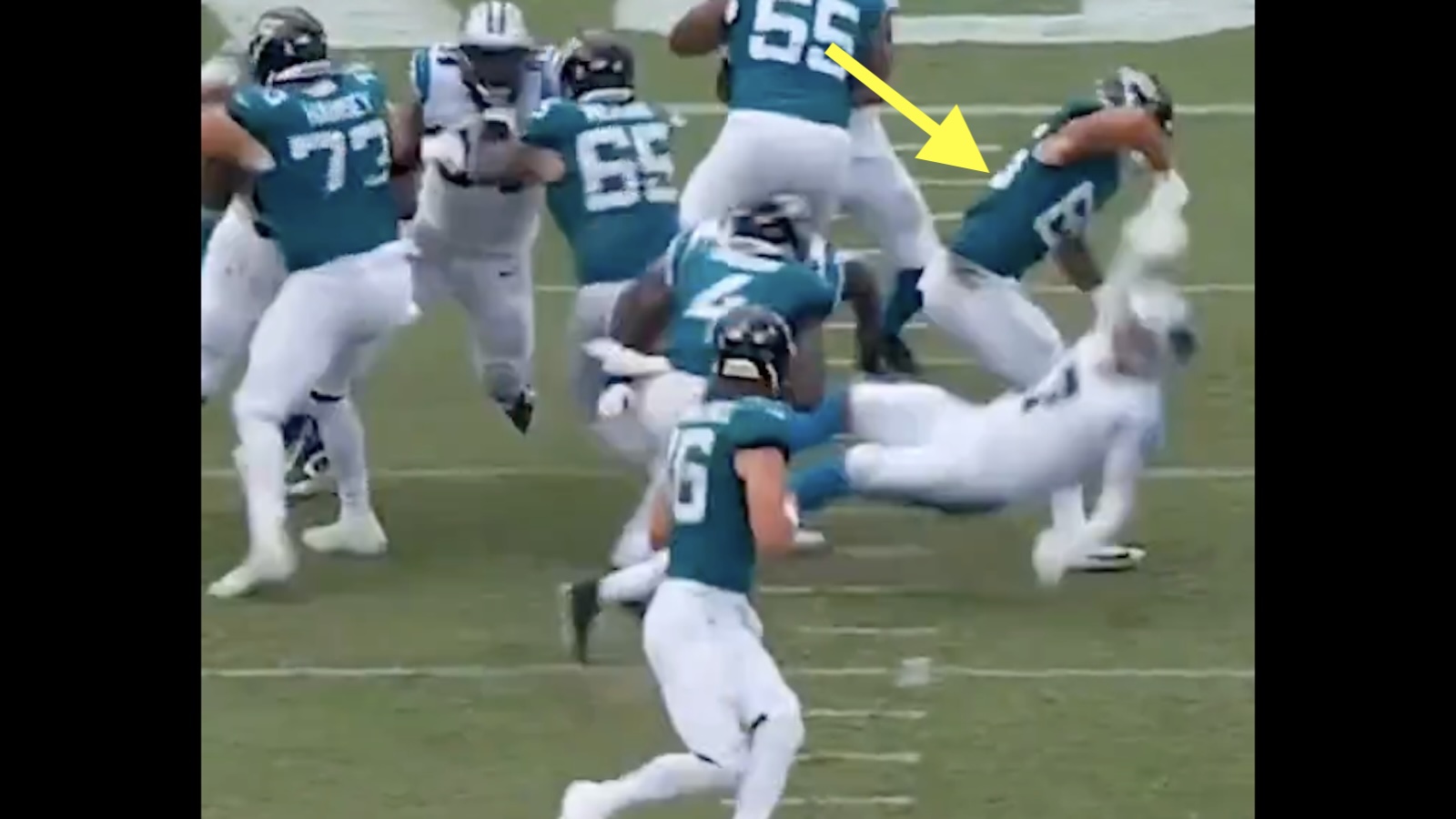 Brenton Strange levels a Panthers player with a block