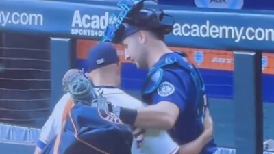Cal Raleigh gets a home run ball back from the Astros bullpen catcher