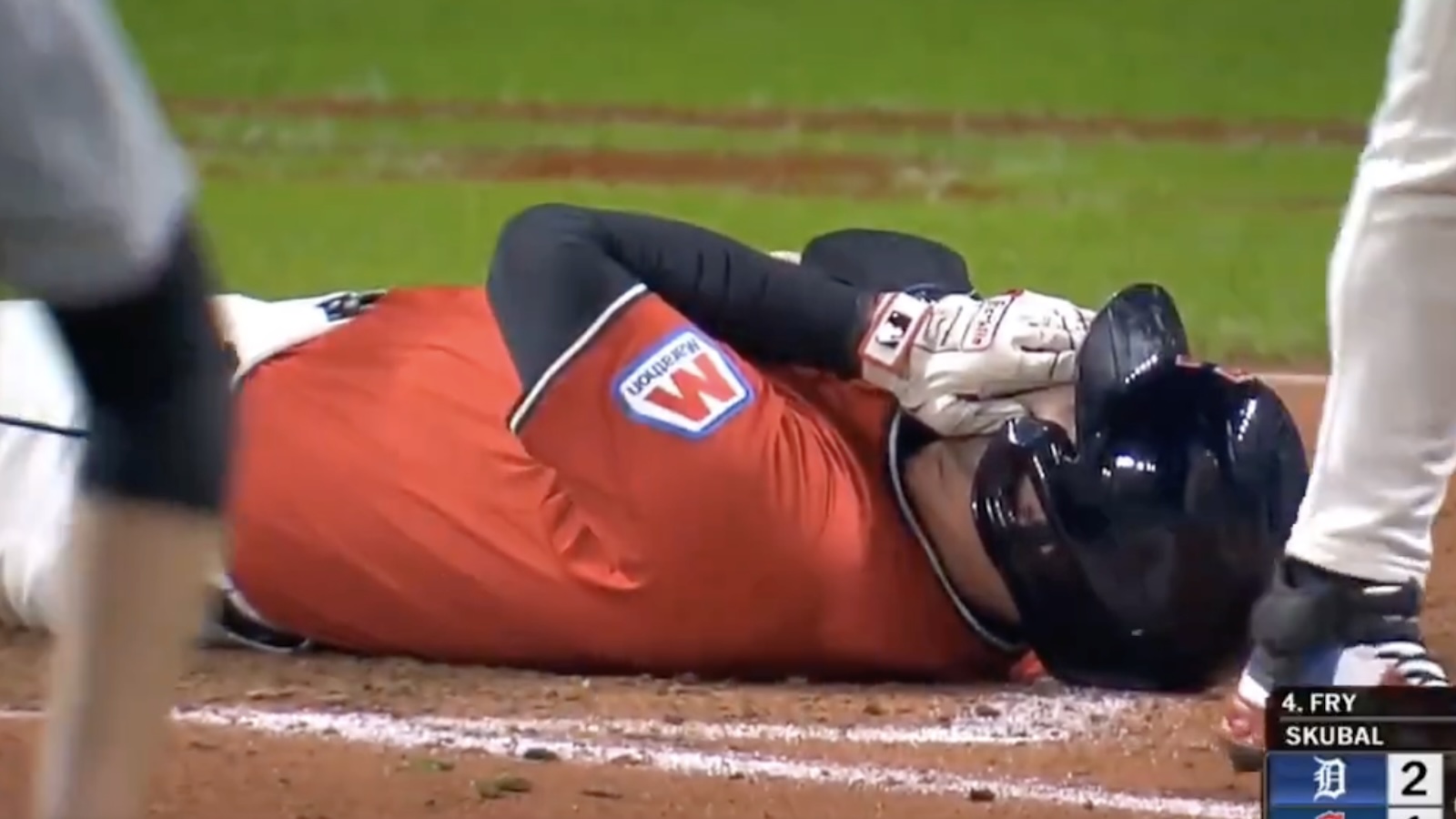 David Fry holds his face after being hit by a pitch