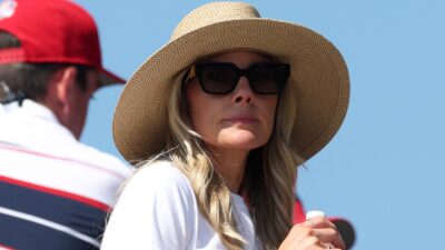 Erica Stoll looks on