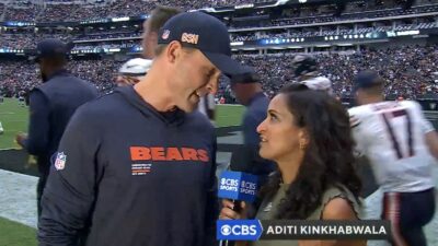Bears coach Ben Johnson being interviewed by CBS sideline reporter Aditi Kinkhabwala