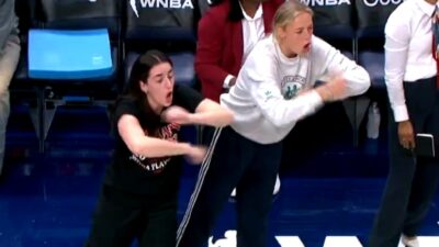 Caitlin Clark and Sophie Cunningham gesturing from the bench