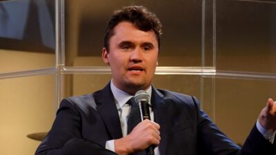 Charlie Kirk holding a microphone