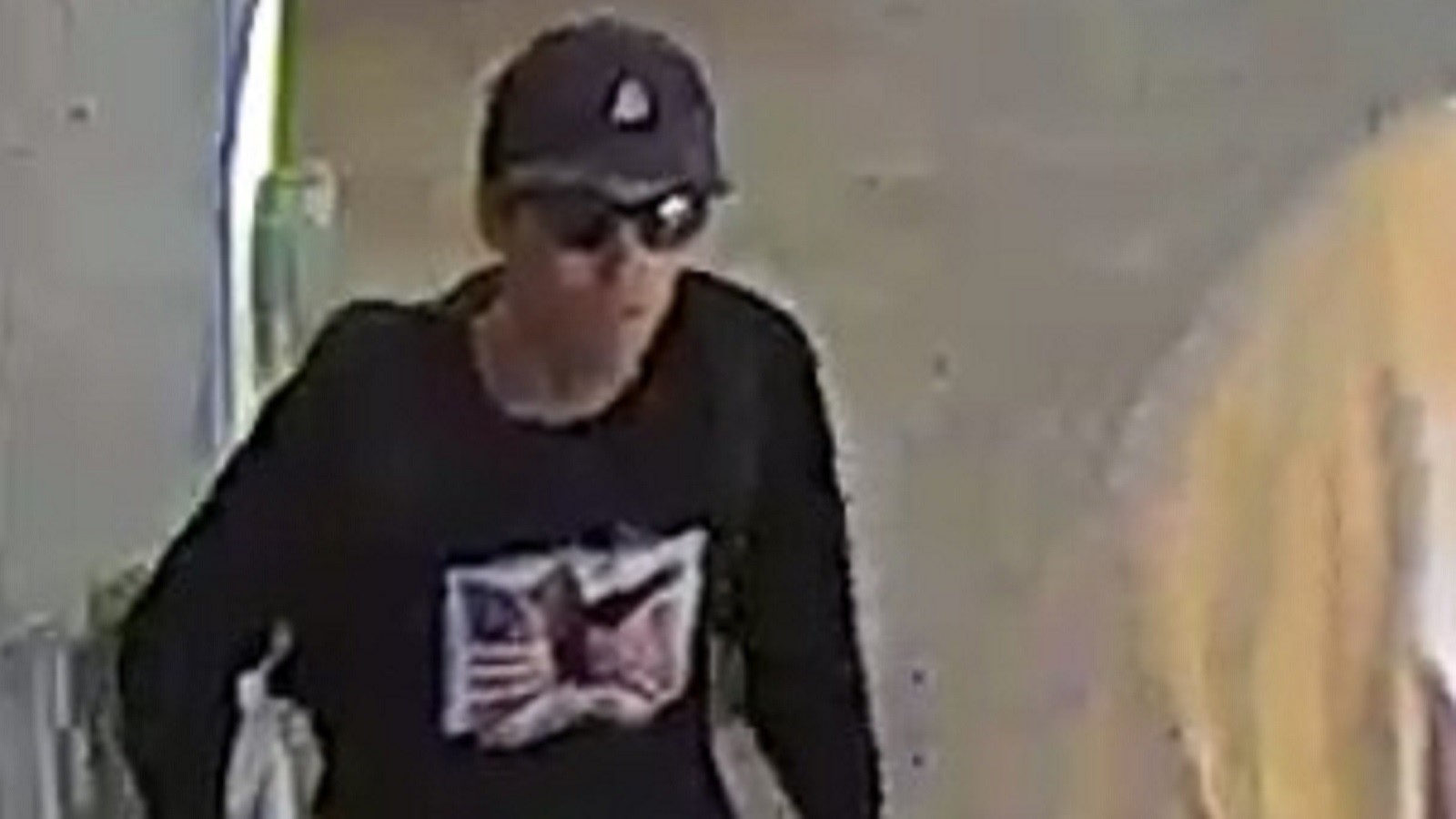 A person with a black hat on and sunglasses