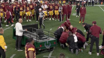 Commanders player Deatrich Wise Jr. on the field with a leg injury