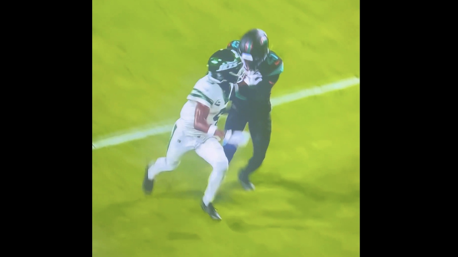 Jets wide receiver Garrett Wilson pushing Dolphins cornerback Jack Jones