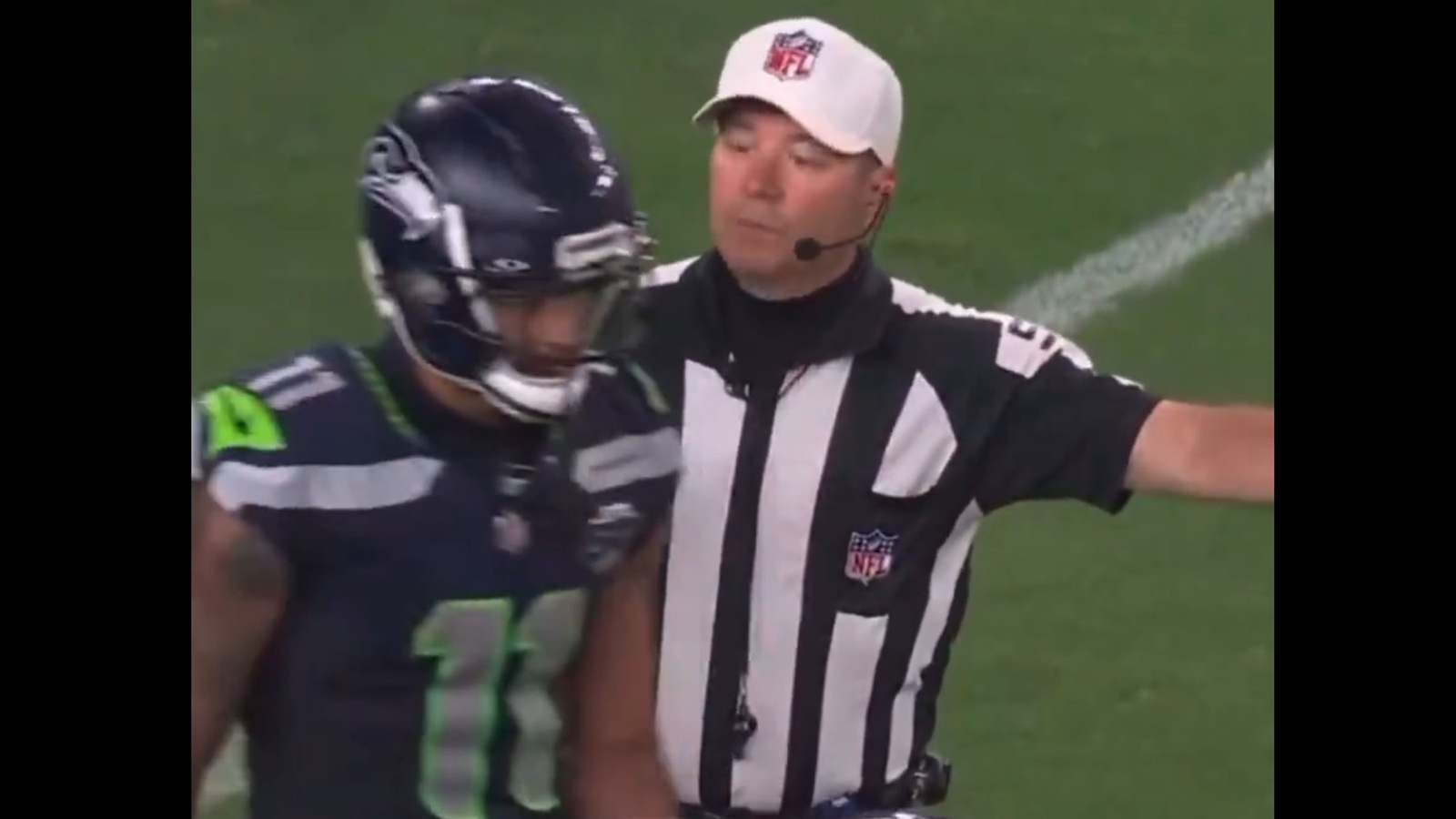 Jaxon Smith-Njigba walking by a referee