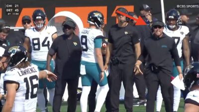 Trevor Lawrence waving off Jaguars head coach Liam Coen
