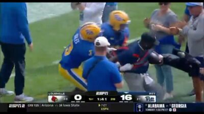 Pitt players fight with a Louisville ball boy