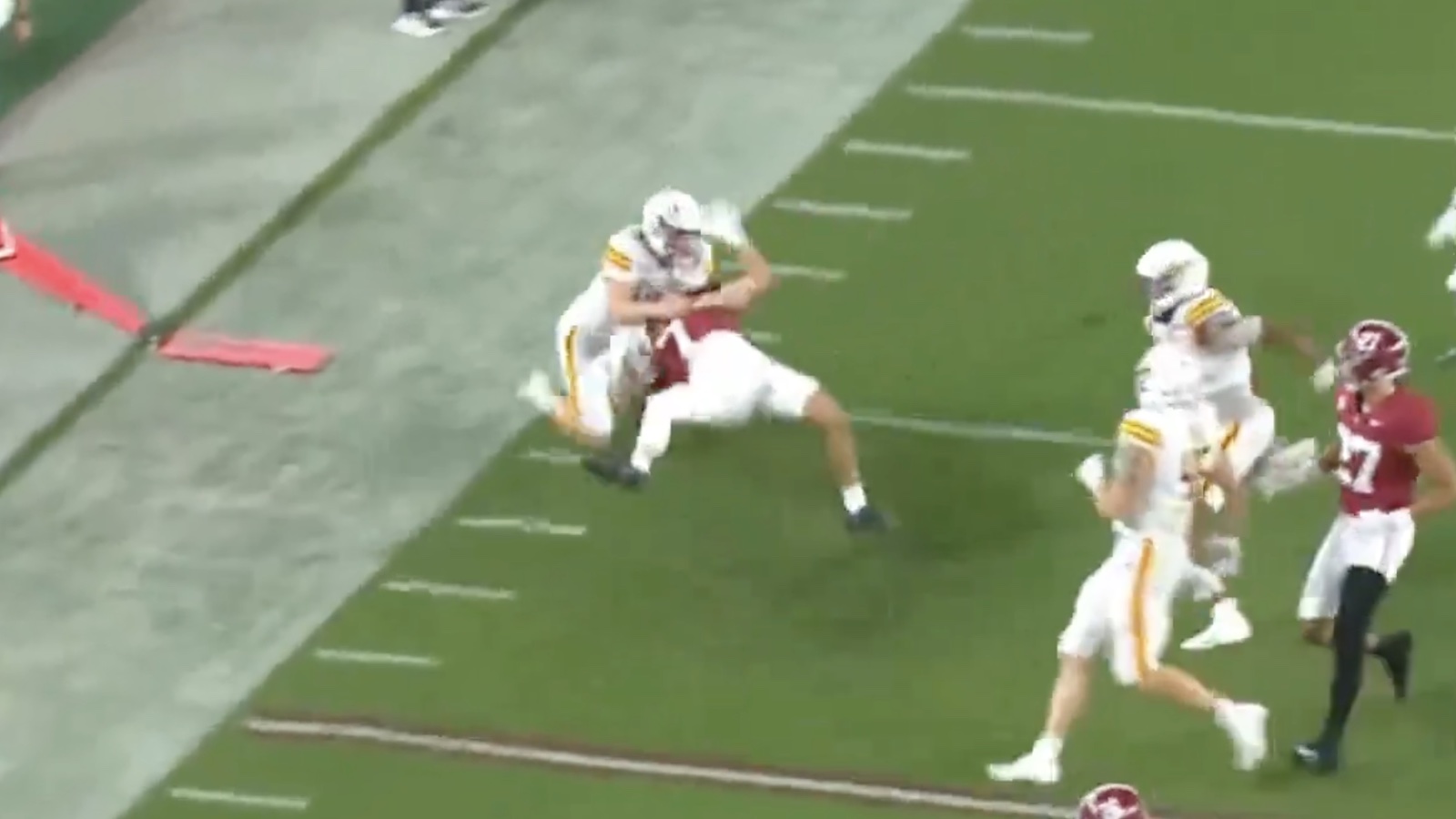 UL-Monroe punter Makenzie Ryan with a hard tackle on Alabama's Cole Adams