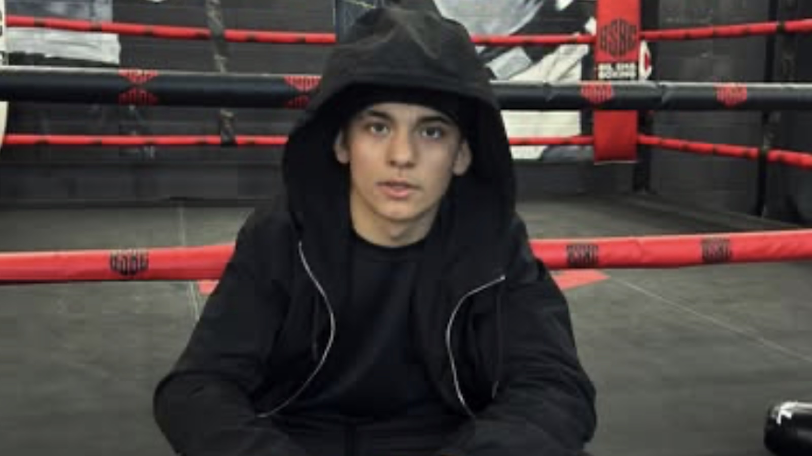 Arturo Gatti Jr. sitting on a boxing ring