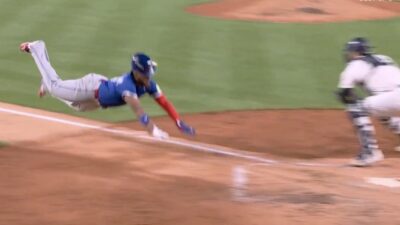 Vladimir Guerrero Jr slides into home plate