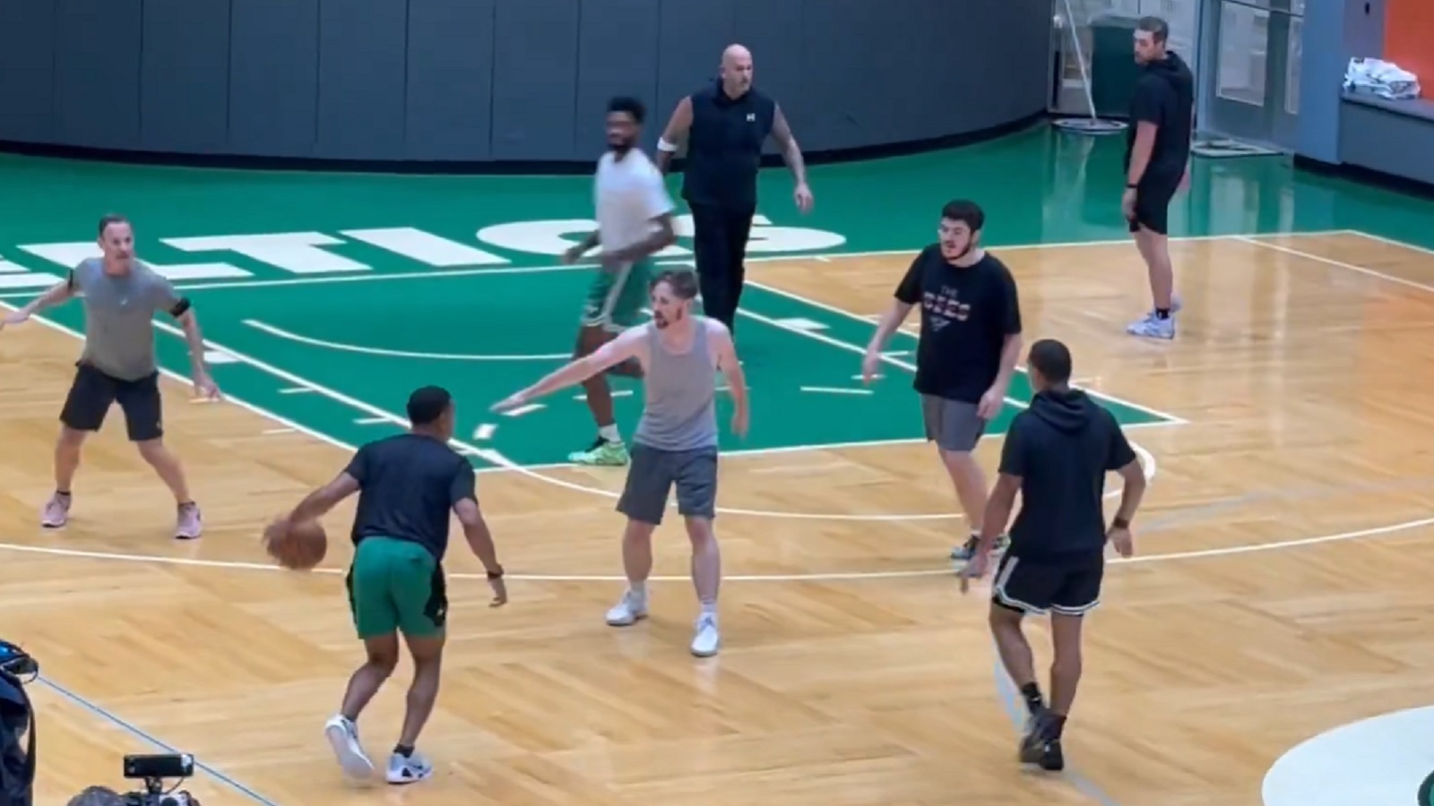Basketball being played on a Celtics court
