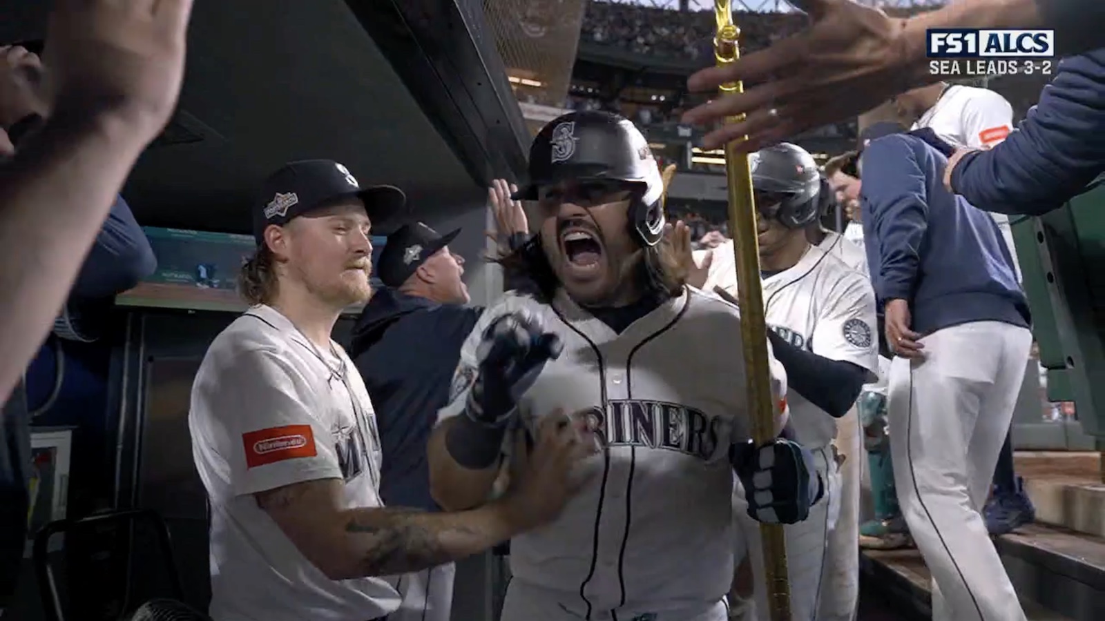 Eugenio Suarez celebrating his Game 5 ALCS grand slam in the Mariners' dugout